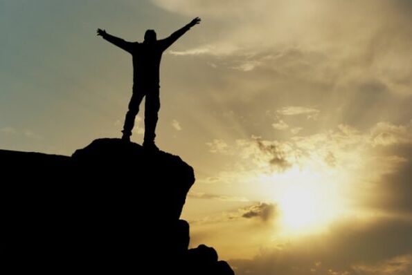 A man on the top of the mountain