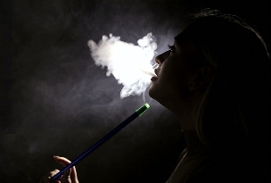 A girl smokes a hookah